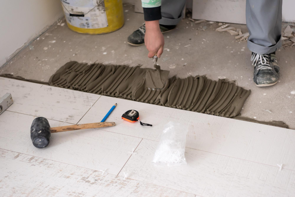 Tiler working on renovation of bathroom floor